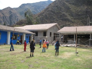 Kids playing volleyball in the center of the school, where P.E. is held.